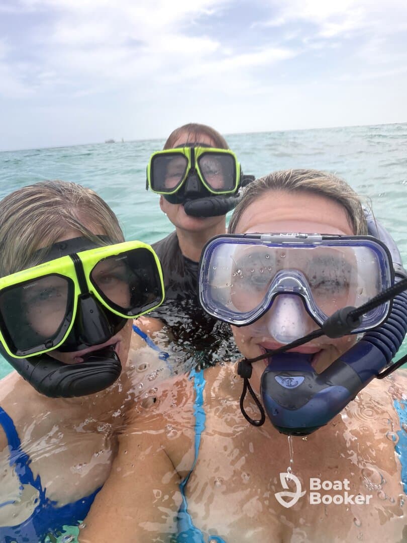 A group of friends enjoys snorkeling in clear waters, showcasing the excitement of underwater exploration and aquatic adventures.