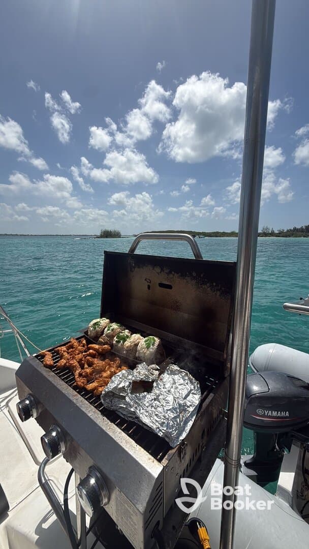 A well-equipped grill on a boat showcases delicious food being prepared, perfect for a fun day on the water.