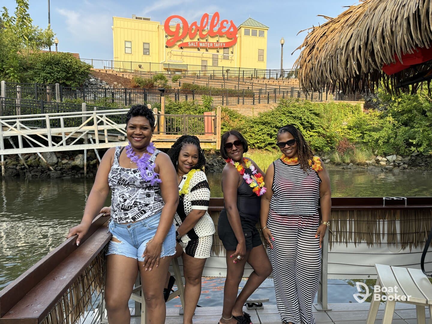 A group of friends poses for a fun photo on a boat, celebrating together at a waterfront location — perfect for memorable outings and gatherings.