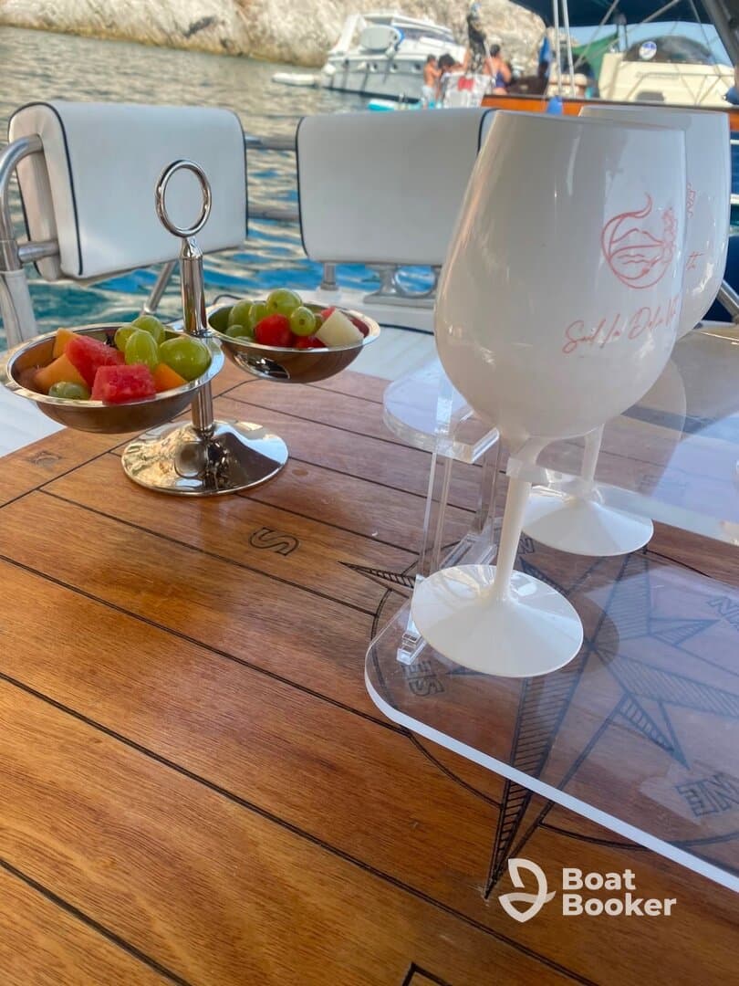 A beautifully arranged snack of fresh fruit and cocktails on a boat table, perfect for enjoying while cruising the waters.
