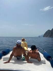 A group enjoys a relaxing day on the boat, soaking up the sun and taking in the ocean views — perfect for a leisurely getaway.