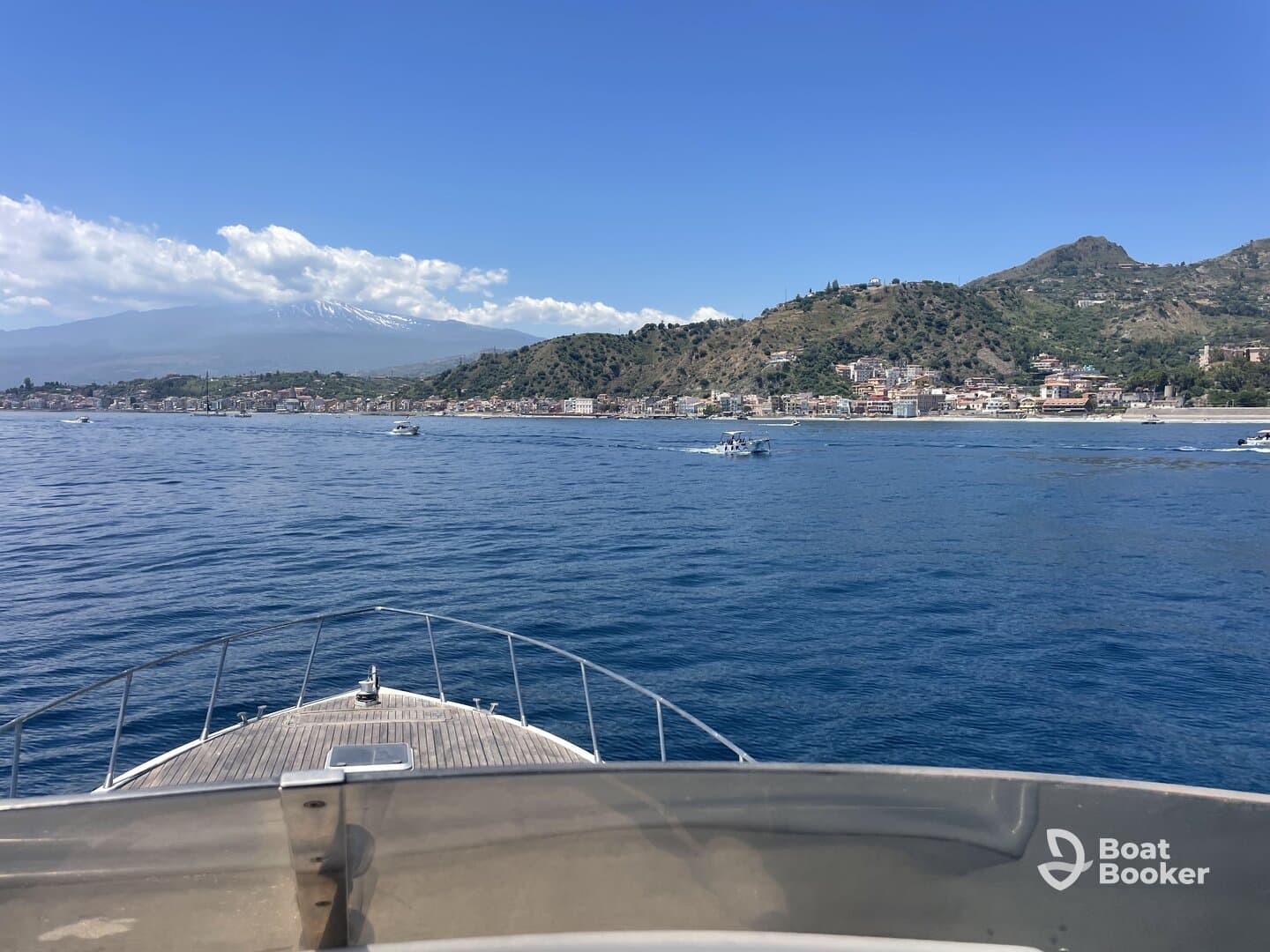 A stunning view from the bow of a boat, showcasing the picturesque coastline and mountains in the background — perfect for exploring scenic destinations.