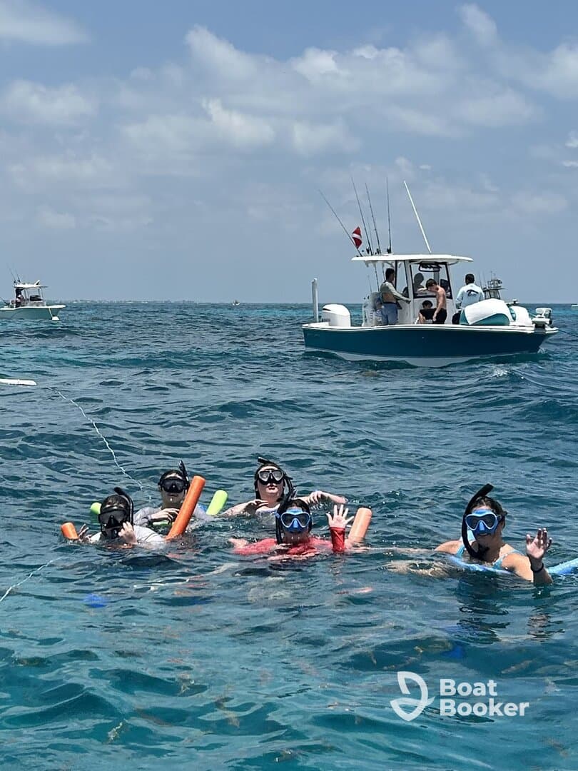 A lively group enjoys snorkeling in clear waters, showcasing the fun and excitement of underwater exploration.