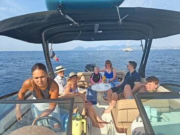 A lively group enjoys a sunny day on the water aboard a boat, creating unforgettable memories together with family and friends.