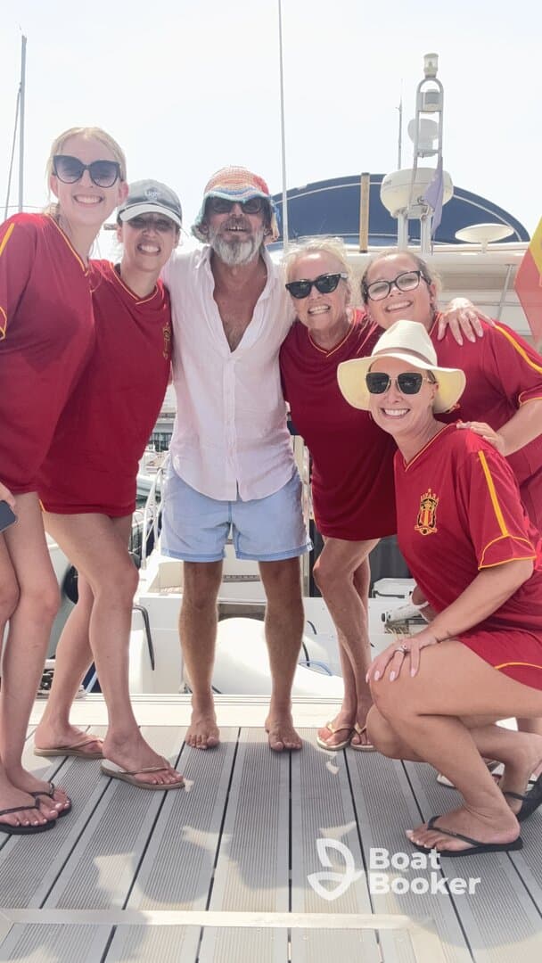 A cheerful group of friends poses together on the deck of a boat, capturing a memorable moment of celebration and camaraderie on the water.