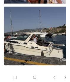 A classic speedboat docked at the marina, showcasing its sleek design and inviting atmosphere. Perfect for day trips and water adventures.