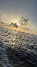 A stunning sunset over the ocean, capturing the serene beauty of a boating experience — perfect for those seeking picturesque views on the water.