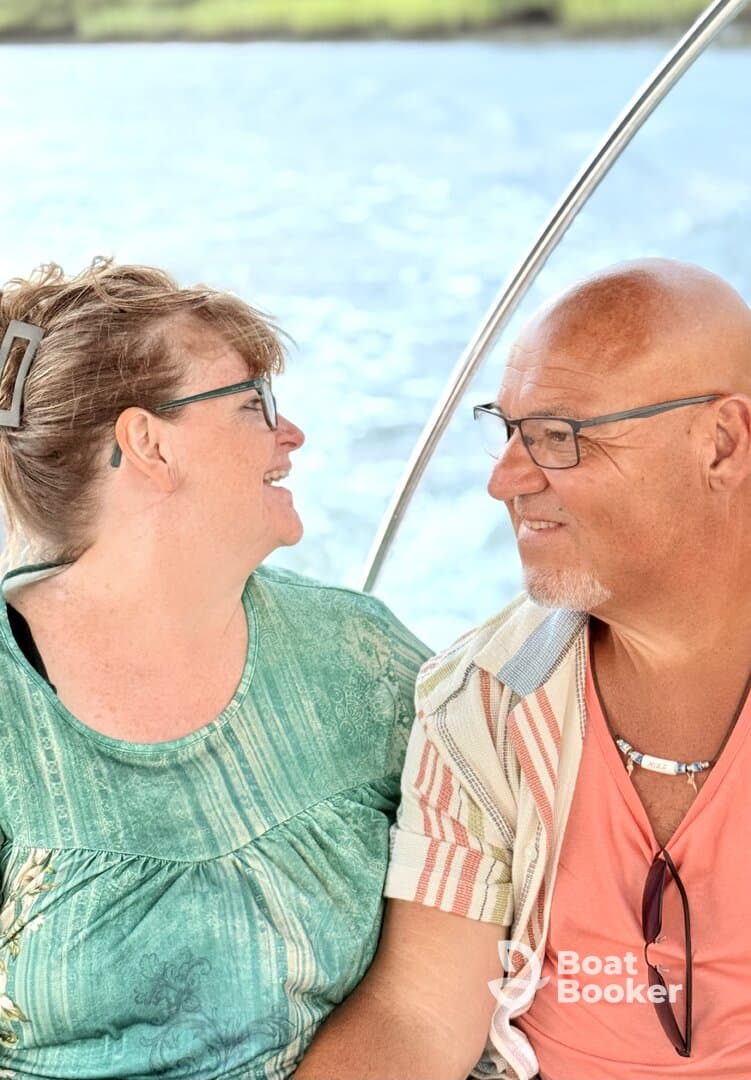 A joyful couple shares a moment on a boat, showcasing the perfect atmosphere for romantic getaways or memorable adventures on the water.