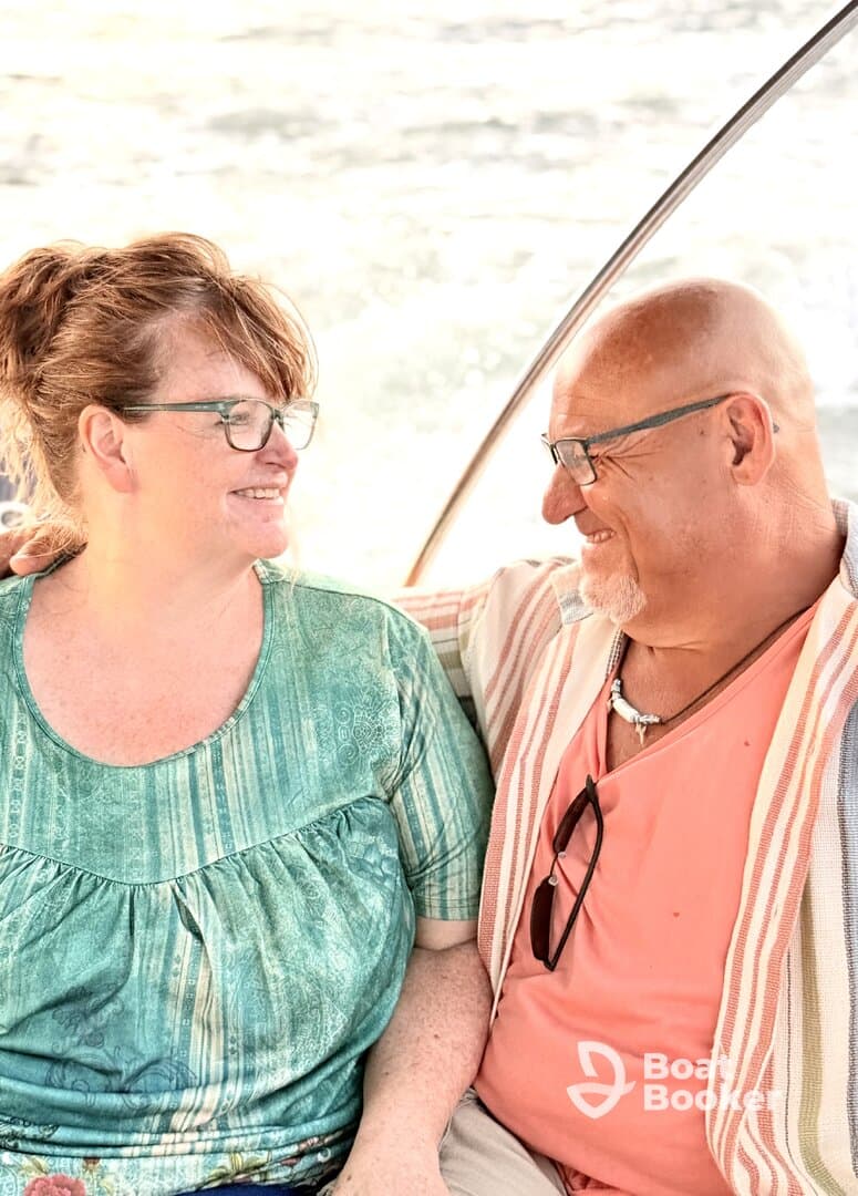 A happy couple shares a moment on a boat, showcasing the joy of romantic outings on the water.