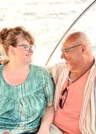A happy couple shares a moment on a boat, showcasing the joy of romantic outings on the water.