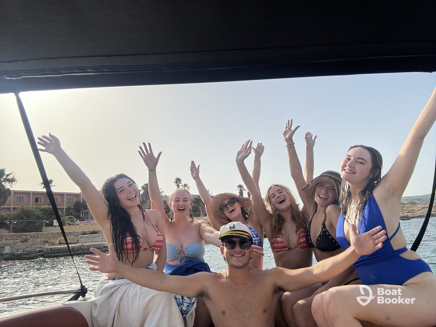 A lively group of friends celebrates on a boat, enjoying the sun and each other's company — perfect for summer outings and memorable adventures on the water.