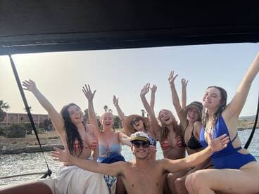 A lively group of friends celebrates on a boat, enjoying the sun and each other's company — perfect for summer outings and memorable adventures on the water.