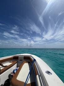 A stunning view from the deck of a speedboat, showcasing the vibrant turquoise waters and clear blue skies, perfect for a day of adventure on the water.