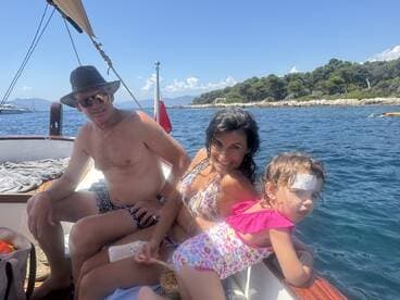 A joyful family enjoys a sunny day on a boat, creating lasting memories together. Perfect for family outings and summer adventures on the water.