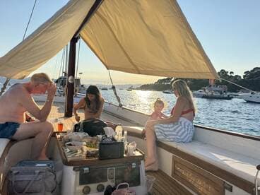A joyful family enjoys their time on a boat at sunset, creating cherished memories with laughter and shared moments.