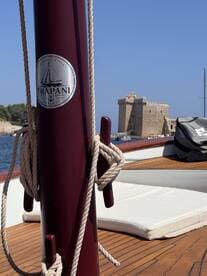 A close-up view of the helm area on a boat, showcasing the polished wood deck and nautical details, perfect for those interested in boat interiors and design.