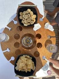 A beautifully arranged selection of snacks and drinks on a boat table, perfect for enjoying a relaxing day on the water.