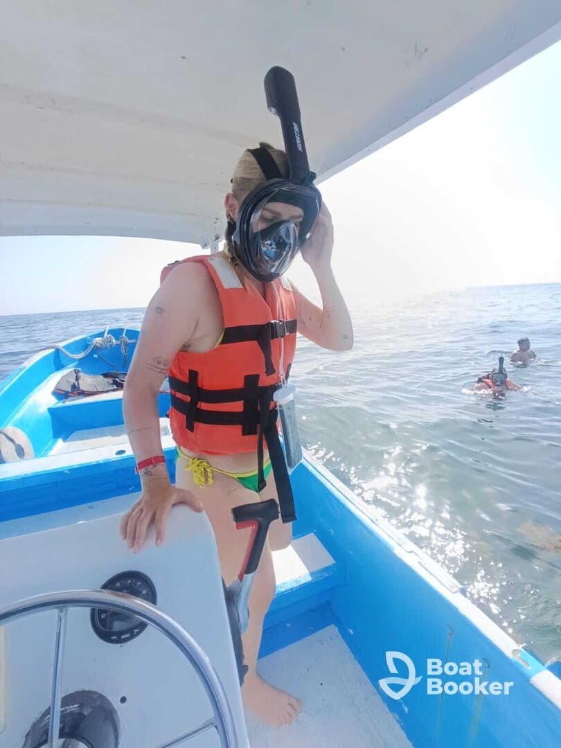 A snorkeler prepares to dive into the water from a boat, showcasing the excitement of underwater exploration. Perfect for adventure seekers looking to enjoy marine life.