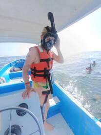 A snorkeler prepares to dive into the water from a boat, showcasing the excitement of underwater exploration. Perfect for adventure seekers looking to enjoy marine life.