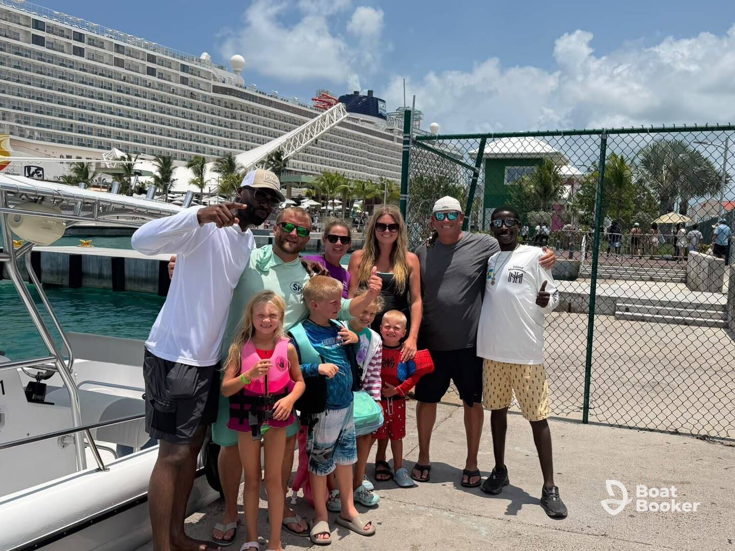 A joyful group of family and friends poses by their boat, ready for a fun-filled day on the water — perfect for family vacations and adventures.