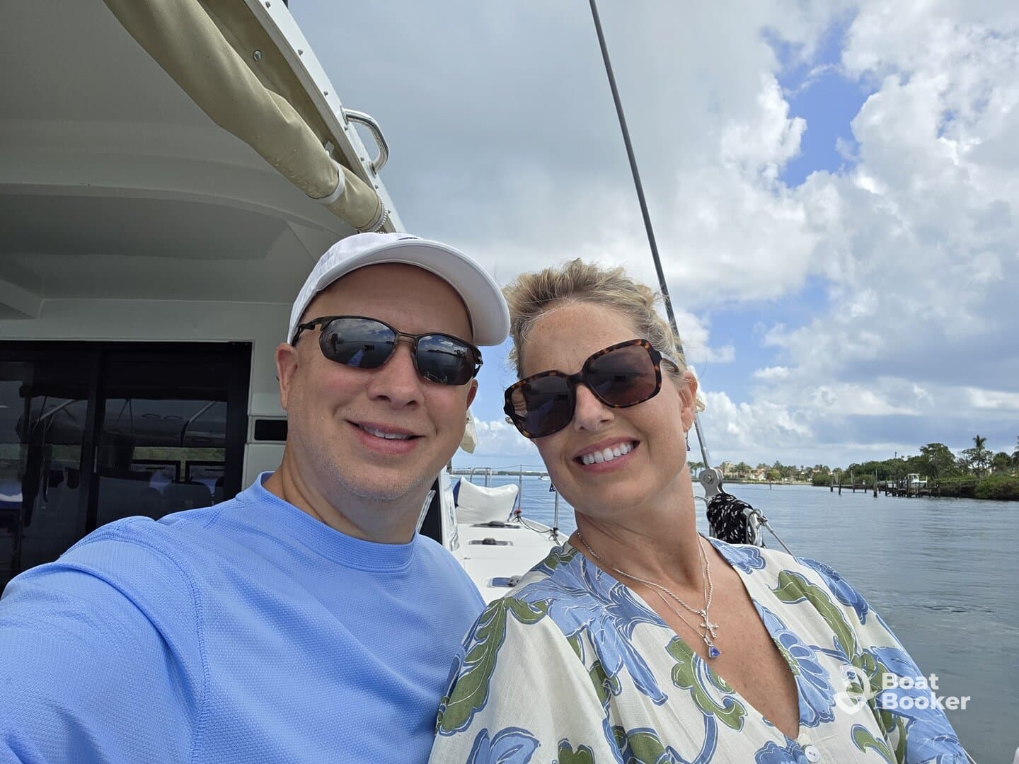 A cheerful couple takes a selfie on a boat, enjoying a beautiful day on the water — perfect for romantic outings or memorable adventures.