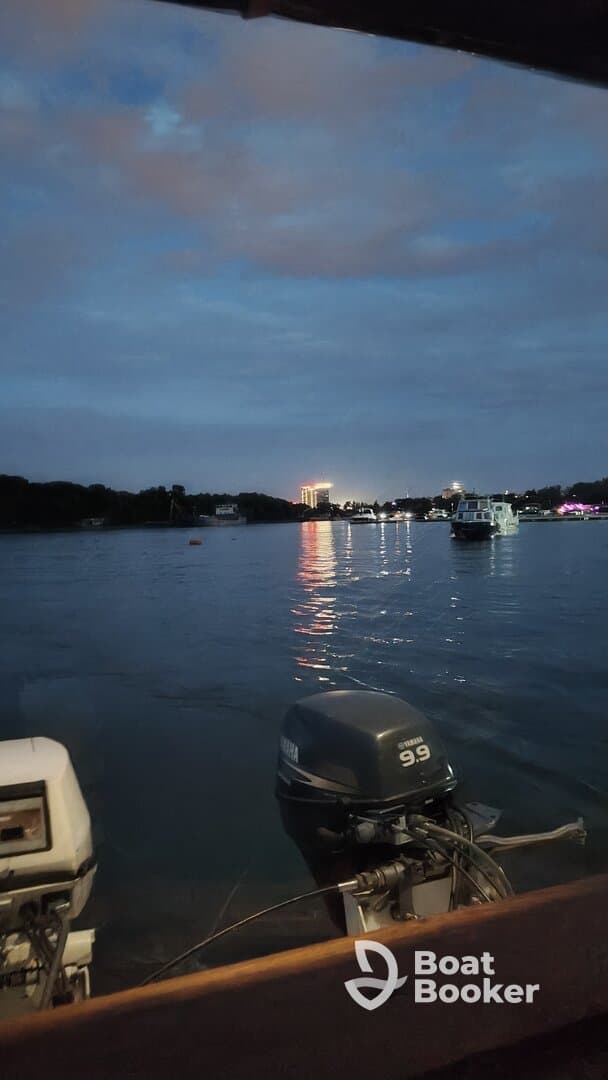 A nighttime view of a waterway with boats and reflections, but the image lacks clarity and focus.