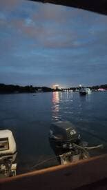 A nighttime view of a waterway with boats and reflections, but the image lacks clarity and focus.
