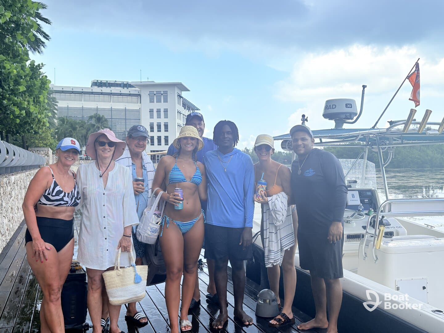 A cheerful group poses together on the dock next to their boat, ready for a fun day on the water. Perfect for family gatherings or friends' outings.