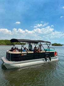 A lively group enjoys a day on a pontoon boat, perfect for socializing and on-water fun in a scenic setting.
