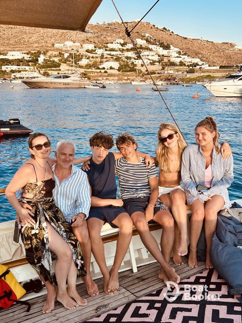 A joyful group of friends and family relaxes on a boat, enjoying the beautiful scenery and each other's company — perfect for memorable summer outings.