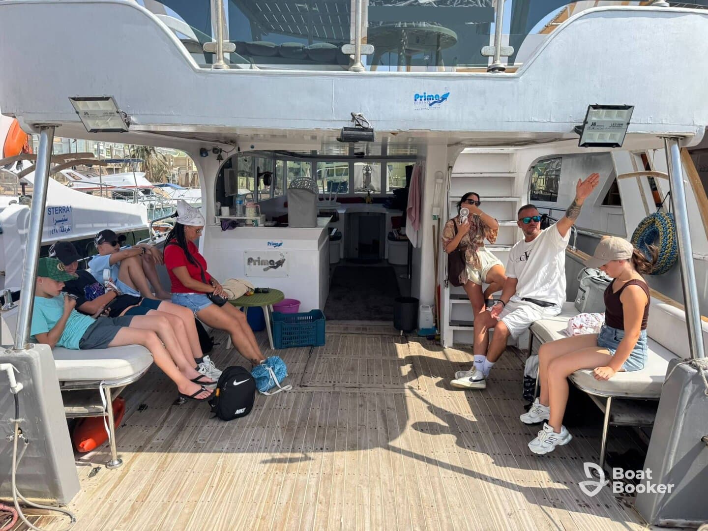 Guests relax inside the cabin of a boat, showcasing comfortable seating and a welcoming atmosphere for a day on the water.