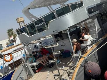 A lively group enjoys their time aboard a boat, capturing moments of fun and celebration in a vibrant atmosphere.