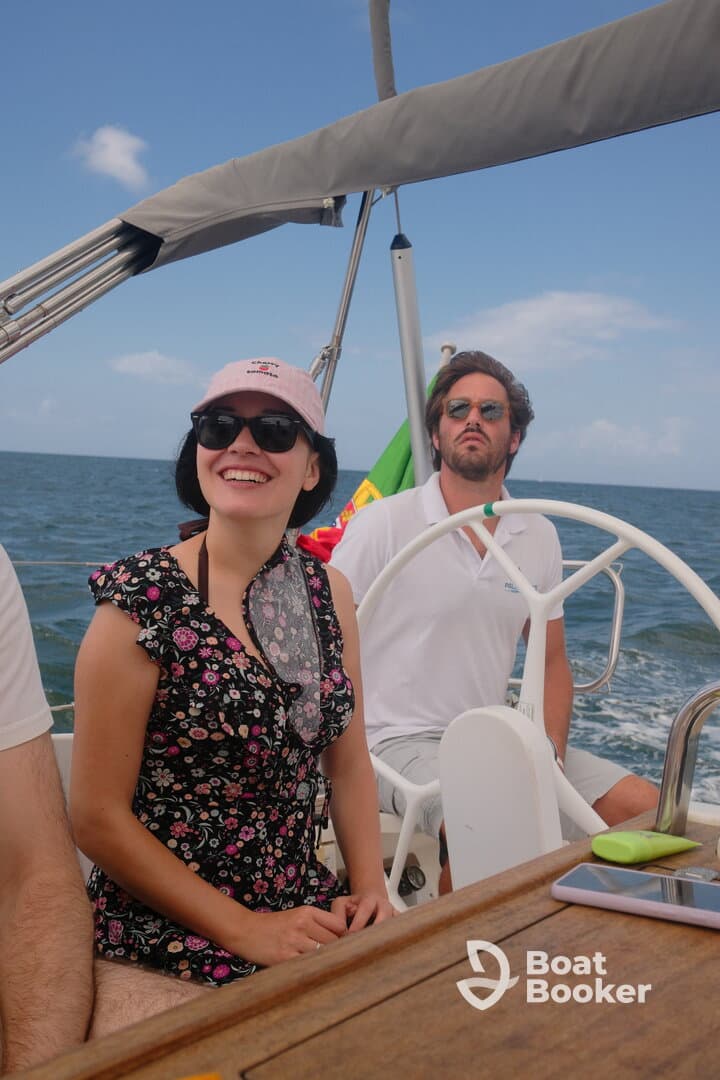 A joyful moment aboard a sailboat with friends, showcasing the fun and excitement of a sailing adventure on the open water.