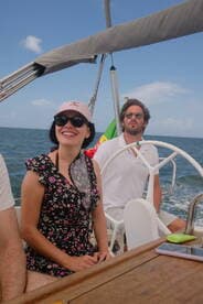 A joyful moment aboard a sailboat with friends, showcasing the fun and excitement of a sailing adventure on the open water.