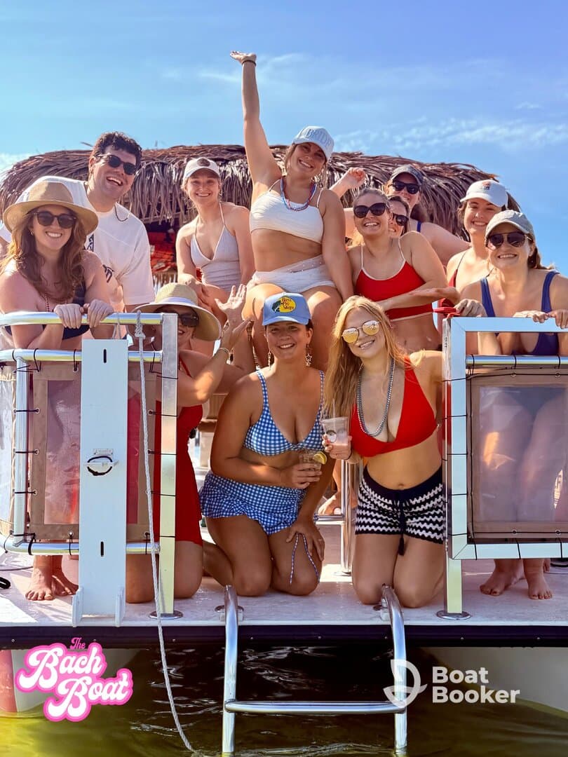 A lively group of friends celebrates on a boat, perfect for bachelorette parties or summer gatherings, enjoying drinks and sunshine.