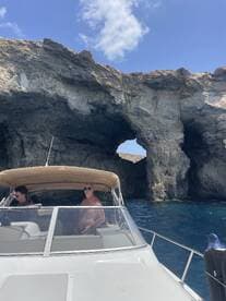 Guests enjoy a scenic boat ride near a stunning rock formation, capturing the essence of adventure on the water.