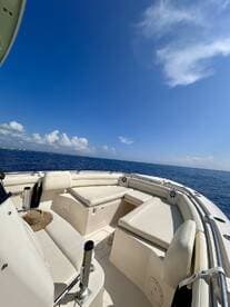 A spacious interior view of a boat's seating area, showcasing comfortable lounge spaces ideal for relaxing on the water.