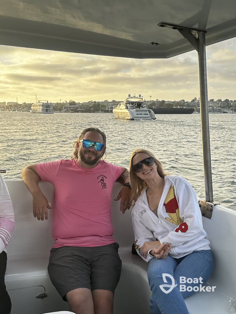 A couple enjoys a scenic boat ride at sunset, capturing the essence of relaxation and celebration on the water.