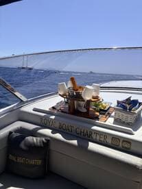 A beautifully arranged spread of snacks and drinks on a luxury boat, perfect for enjoying a day out on the water with friends or family.