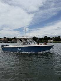 A lively group enjoys a day out on the water aboard a Grady-White boat, showcasing their fishing catch and celebrating their time together.