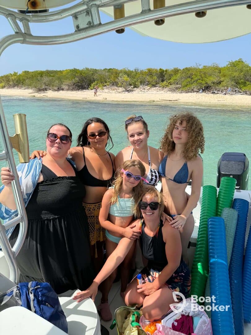 A joyful group of friends and family poses on a boat, ready for a fun day at the beach — perfect for creating lasting memories on the water.