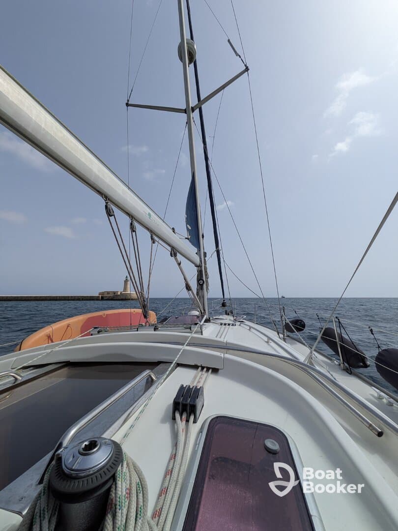 A view from the deck of a sailboat, showcasing the mast and rigging against a clear sky, perfect for sailing enthusiasts and maritime adventures.