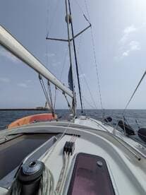 A view from the deck of a sailboat, showcasing the mast and rigging against a clear sky, perfect for sailing enthusiasts and maritime adventures.