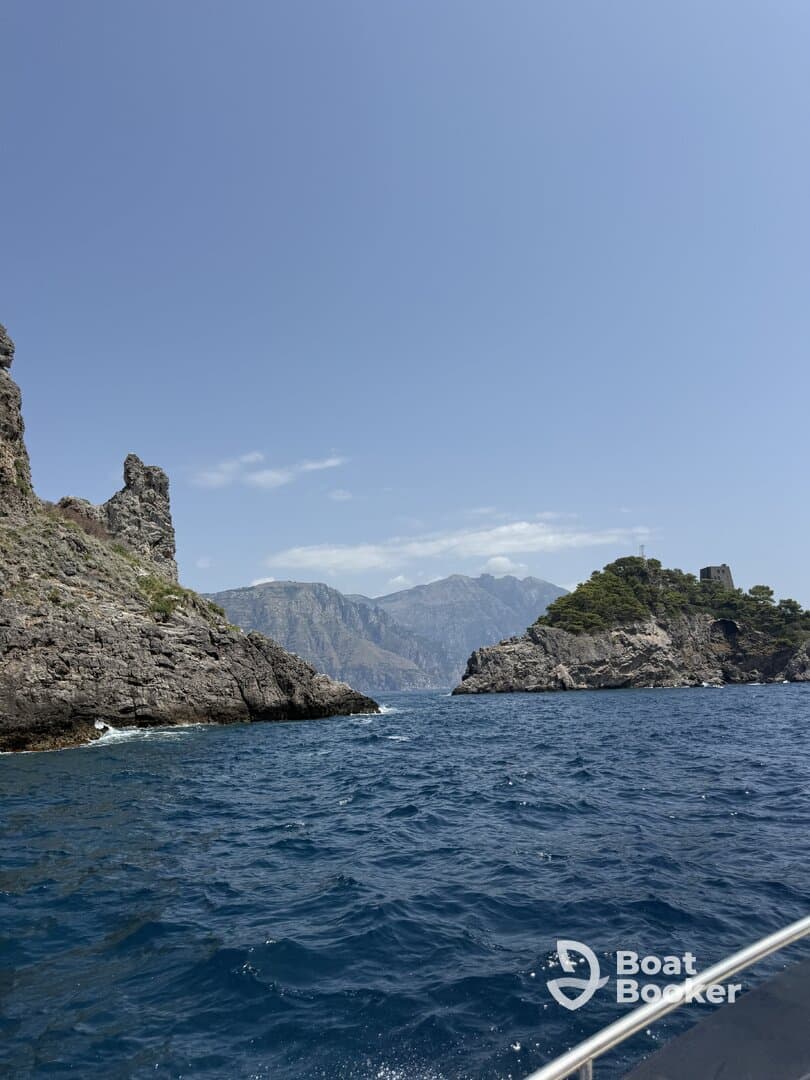 A stunning view of rocky coastlines and islands, showcasing the natural beauty of the area — perfect for exploring by boat.
