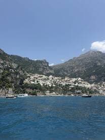 A stunning view of the Amalfi Coast, showcasing picturesque cliffs and charming coastal villages — a perfect destination for boat tours and scenic cruises.