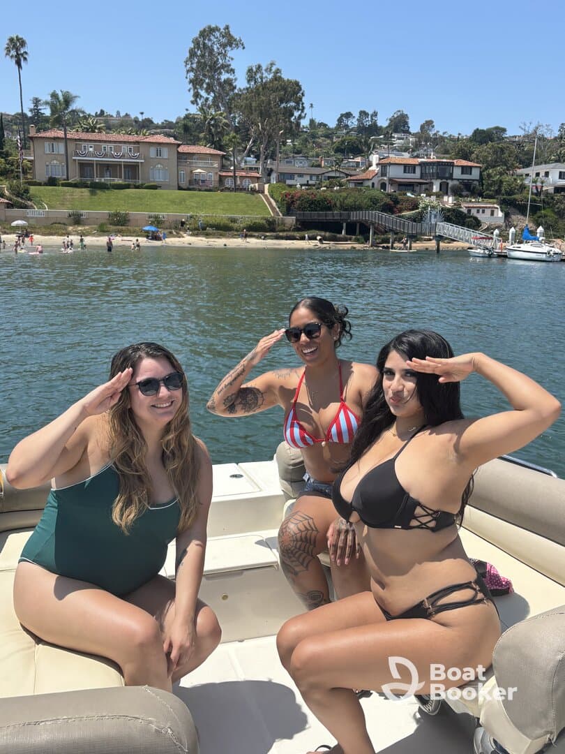 A fun group of friends poses on a boat, enjoying a sunny day on the water — perfect for summer celebrations and outings.