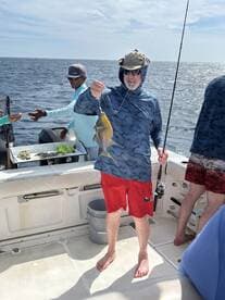 A group of anglers enjoys a fishing trip on the ocean, showcasing a successful catch. The excitement of fishing in open waters makes for an unforgettable experience.