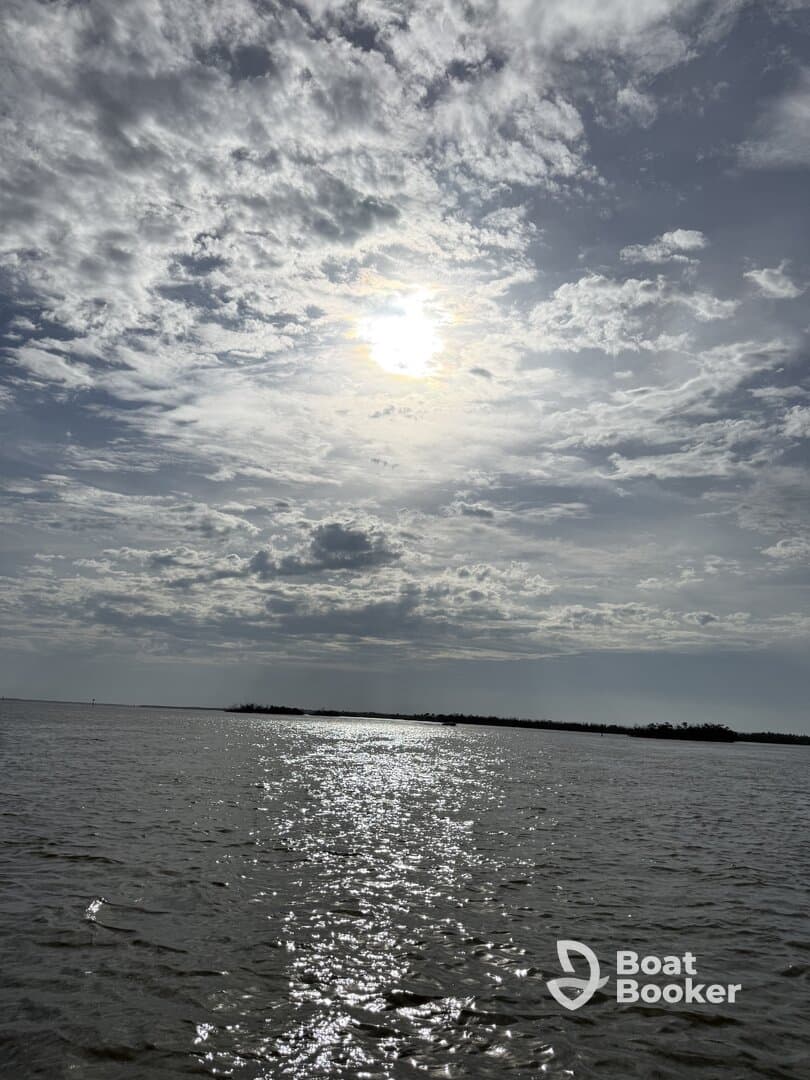 A scenic view of a cloudy sky reflecting on the water, creating a tranquil atmosphere. Ideal for capturing the beauty of nature.