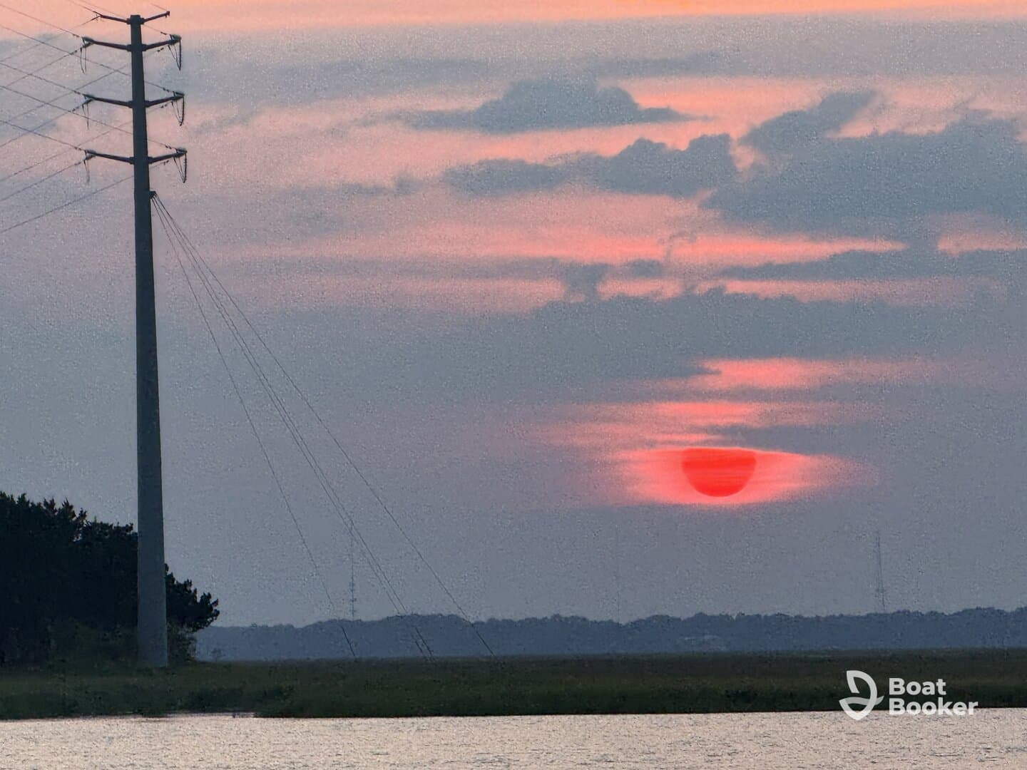 A sunset view with a power line in the foreground, creating an unclear composition.