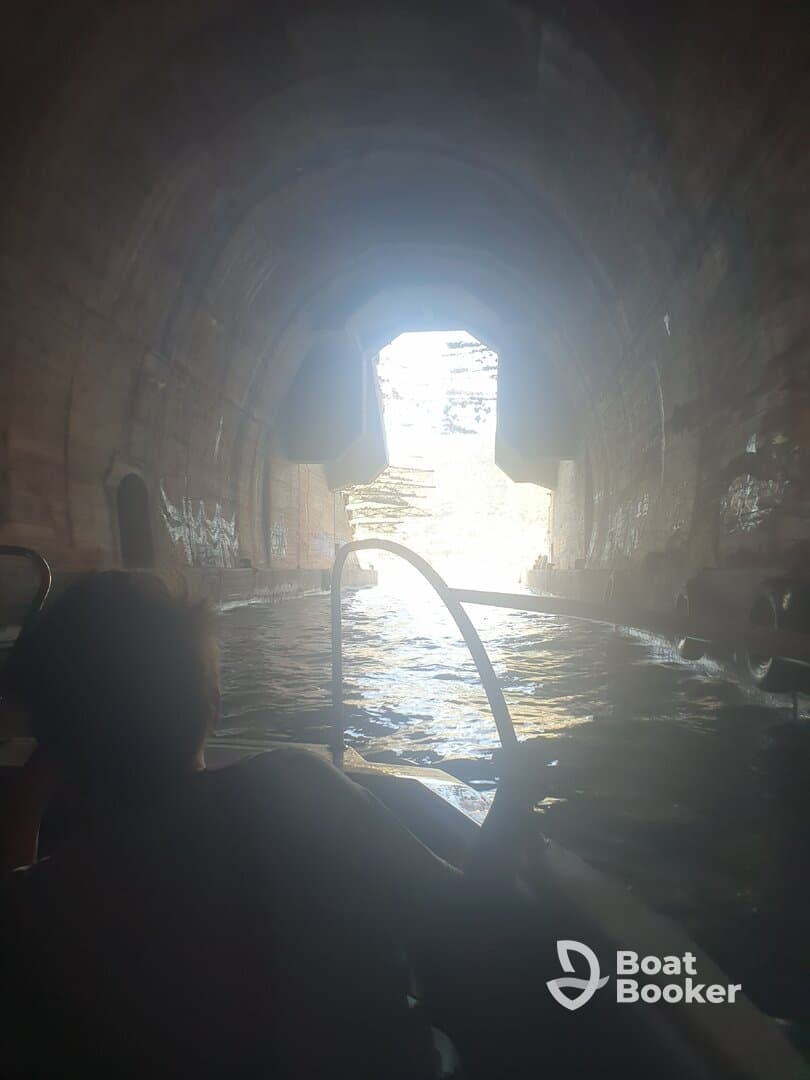 A captivating view from inside a boat as it navigates through a scenic cave, showcasing the adventure of exploring hidden waterways.
